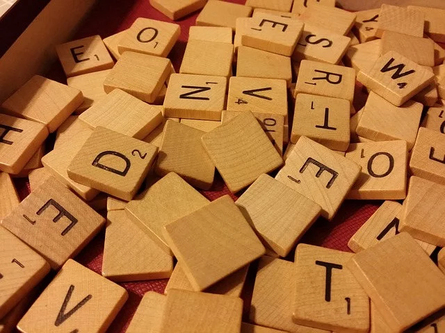 A random assortment of wooden Scrabble tiles.