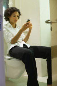 Woman using a mobile while on the loo