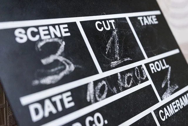 Photo of a movie clapperboard with chalk writing on it.