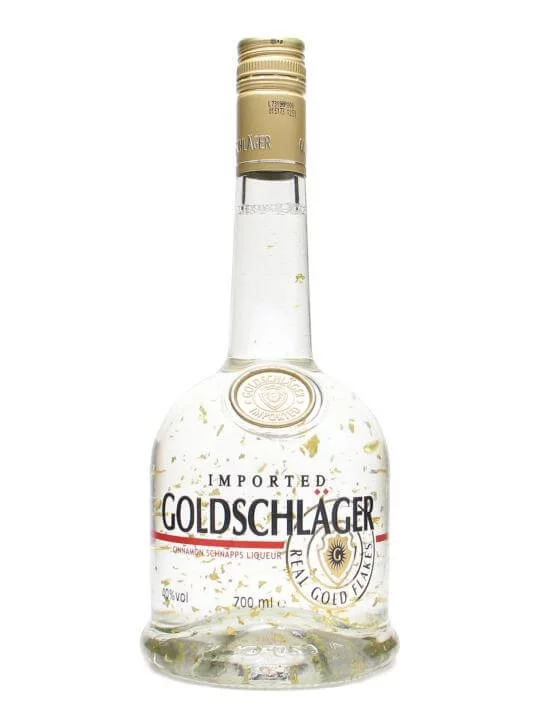 Bottle of Goldschlager. A transparent liquid with floating flakes of gold in it.