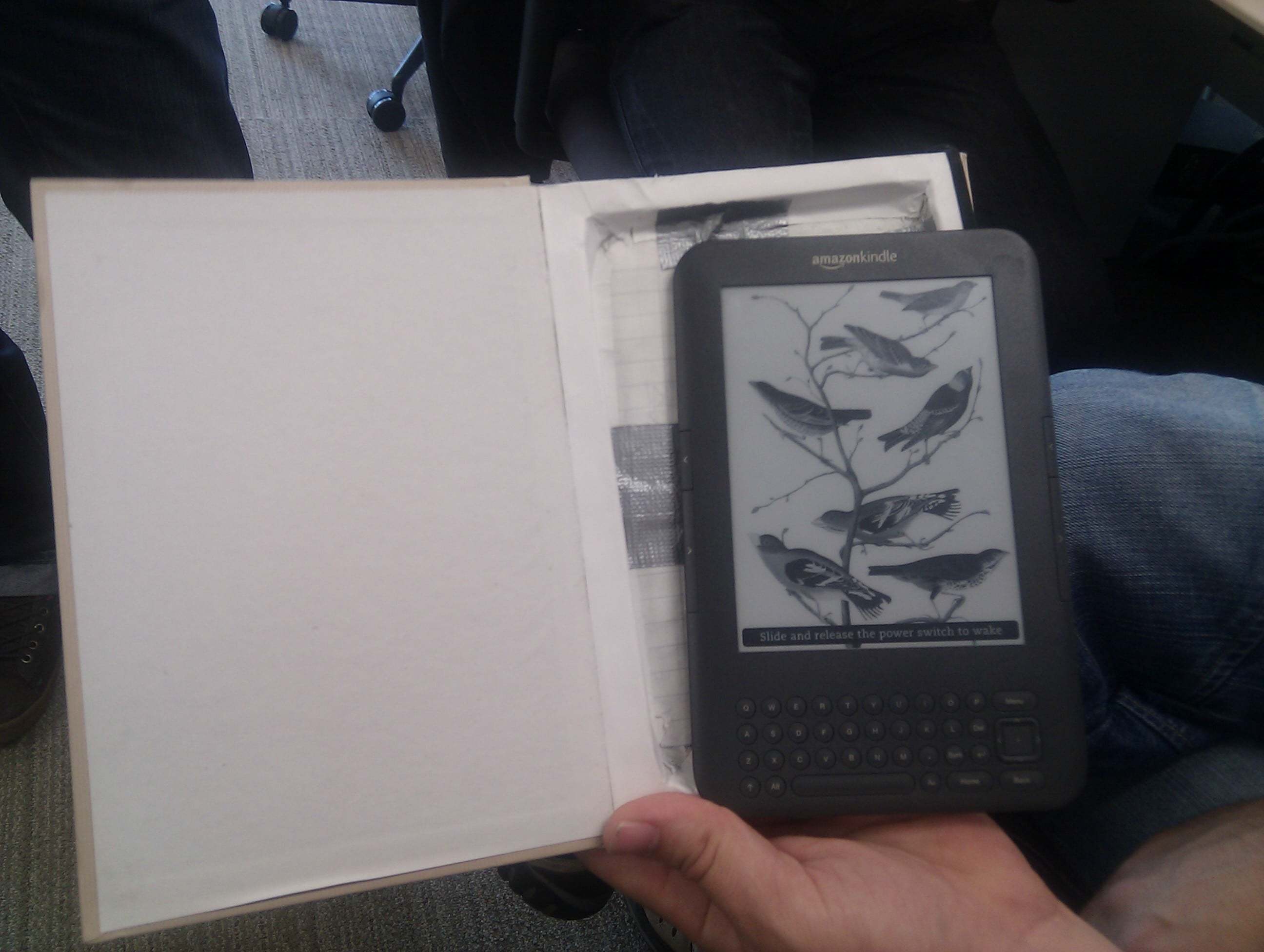 A Kindle hidden in a hollowed out paper book.