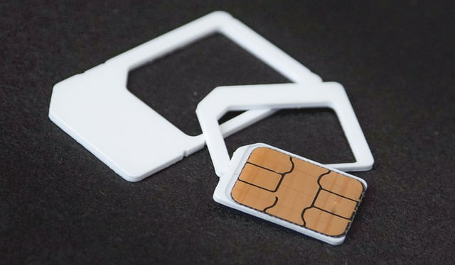 Photo of a nano SIM card and its plastic housing.