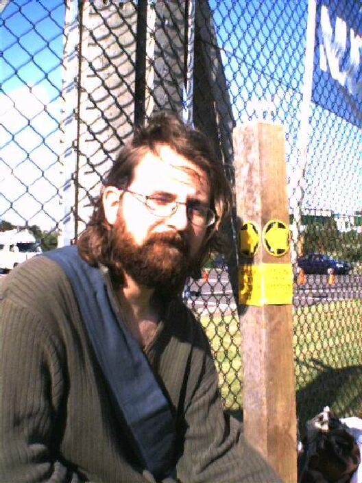 A bearded man stares at the camera.