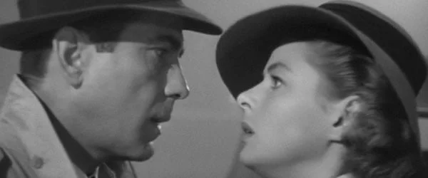 Still from Casablanca. Bogey and Bacall are ready to kiss.