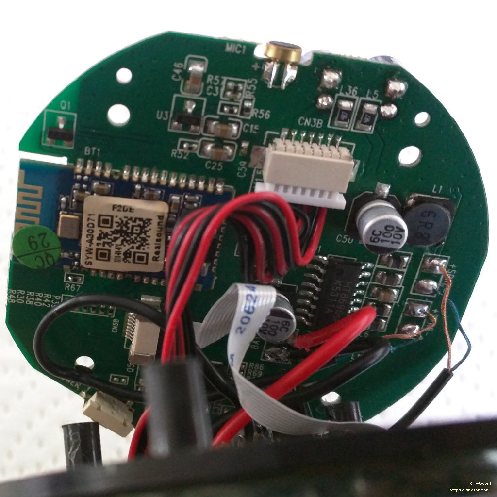 reverse of the circular circuit board showing a bluetooth antenna and microphone