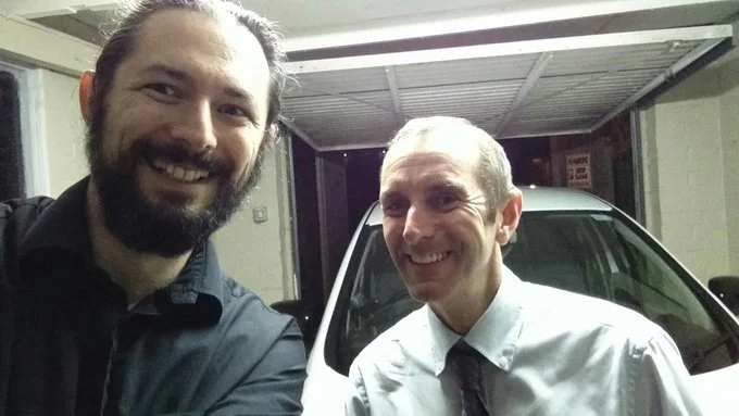 Me and a man from the BBC standing in front of an electric car.