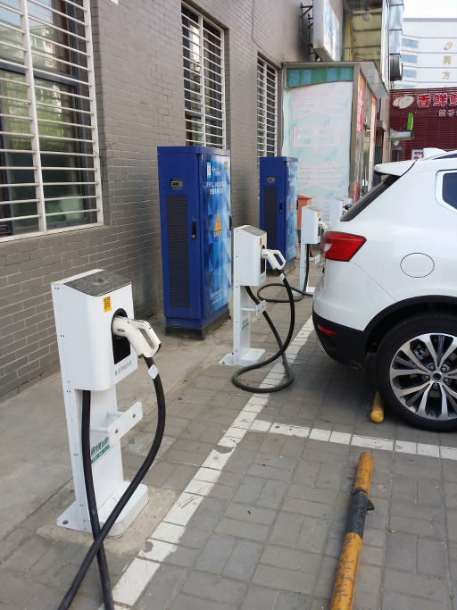 An electric car charging at a public charger.