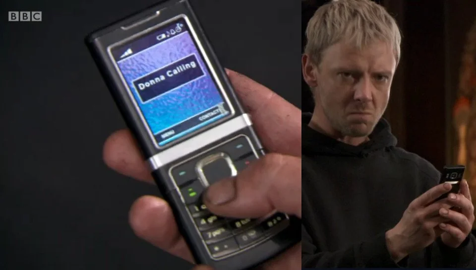 The Master holding a Nokia candybar phone.