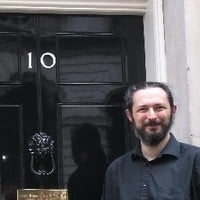 Terence Eden standing outside Number 10 Downing Street.