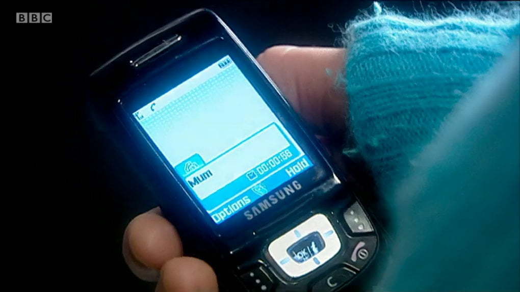 Rose holding a phone which says "mum" on the caller screen.