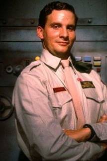 Rimmer wearing a khaki shirt.