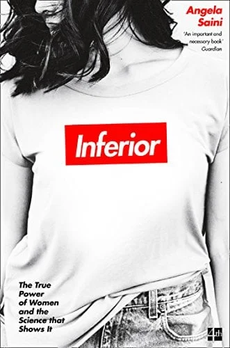 A young woman wears a t-shirt with "Inferior" emblazoned on it.