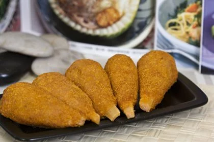 Breaded drumsticks - with a bone sticking out of them.