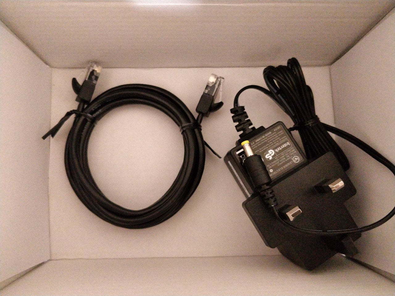 Cables in the box. An ethernet and power plug.