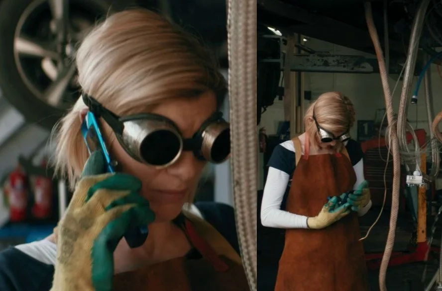 The Doctor holding a blue flip phone.