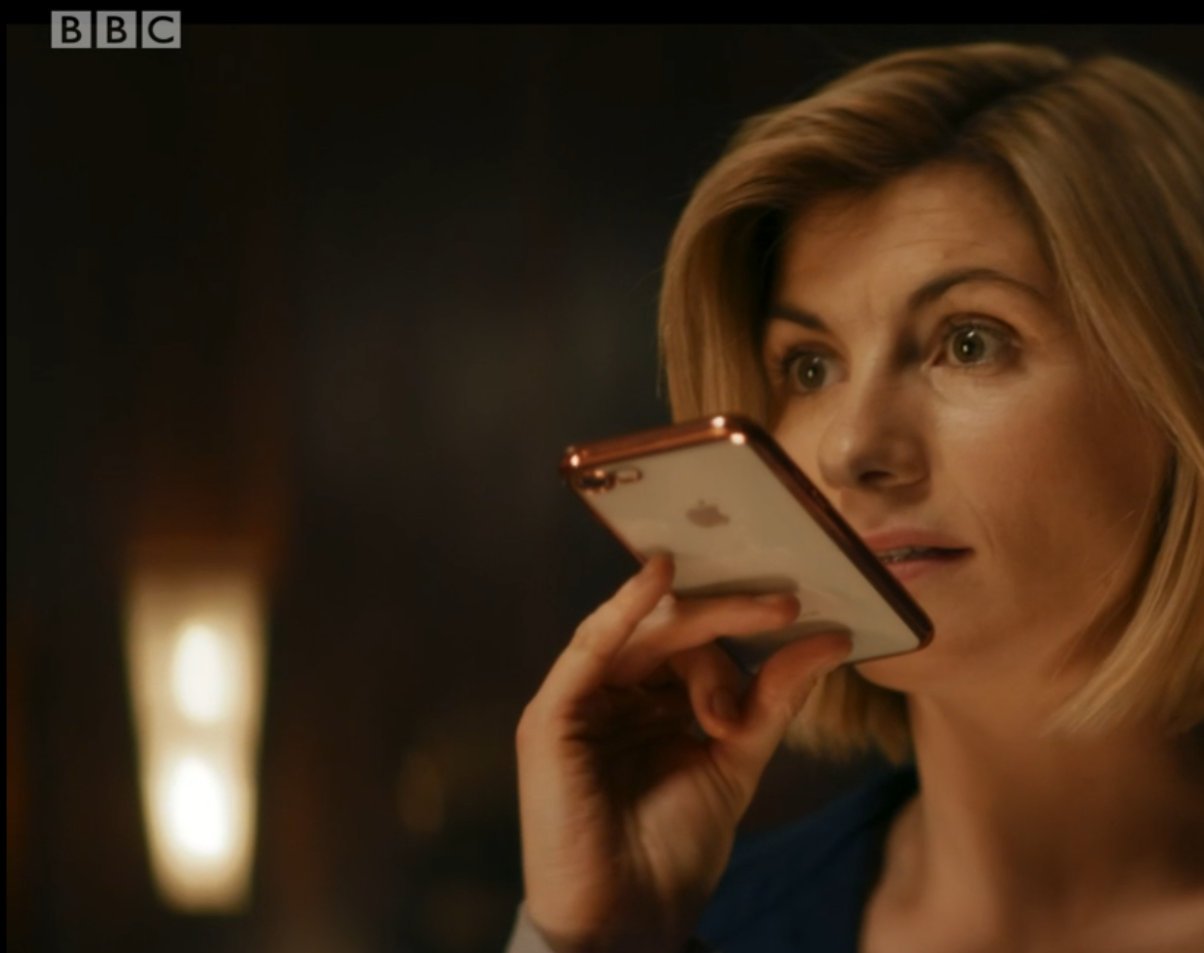 Doctor holding Yaz's phone.