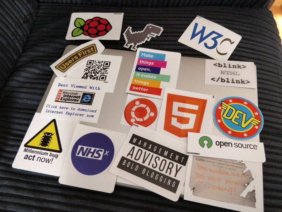 Laptop covered in stickers, still on their backing paper.