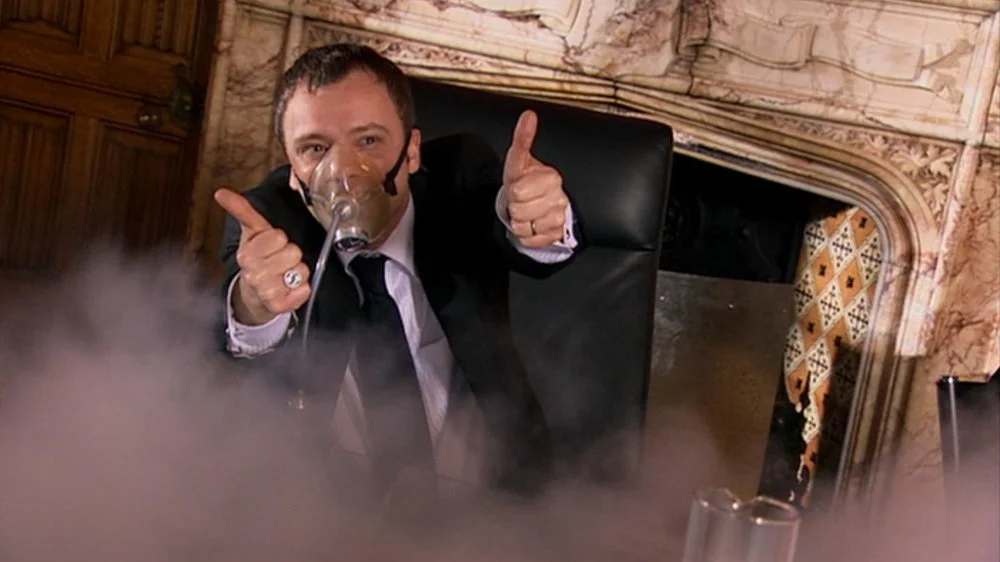 The Master from Doctor Who giving the Thumbs Up in Number 10.