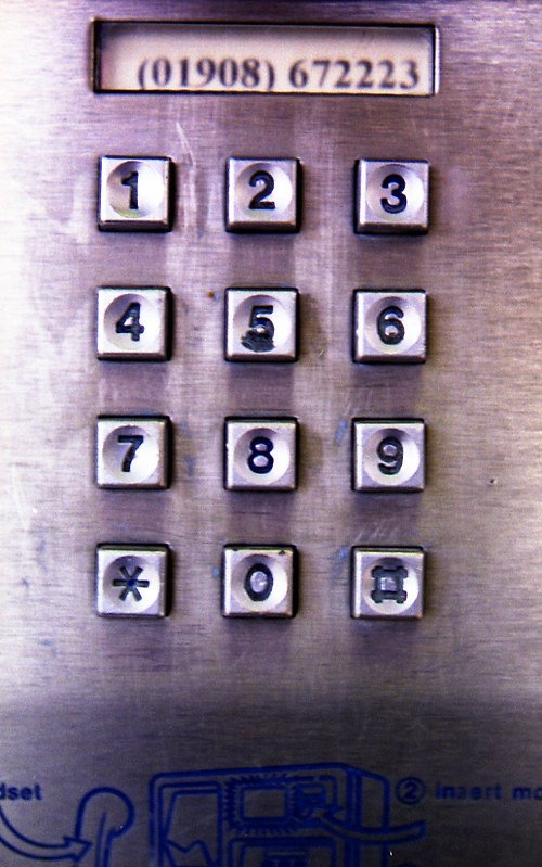 Photo of a BT Payphone dialling pad. There are only numbers visible, no letters. Originally from https://www.flickr.com/photos/joybot/6207493770/