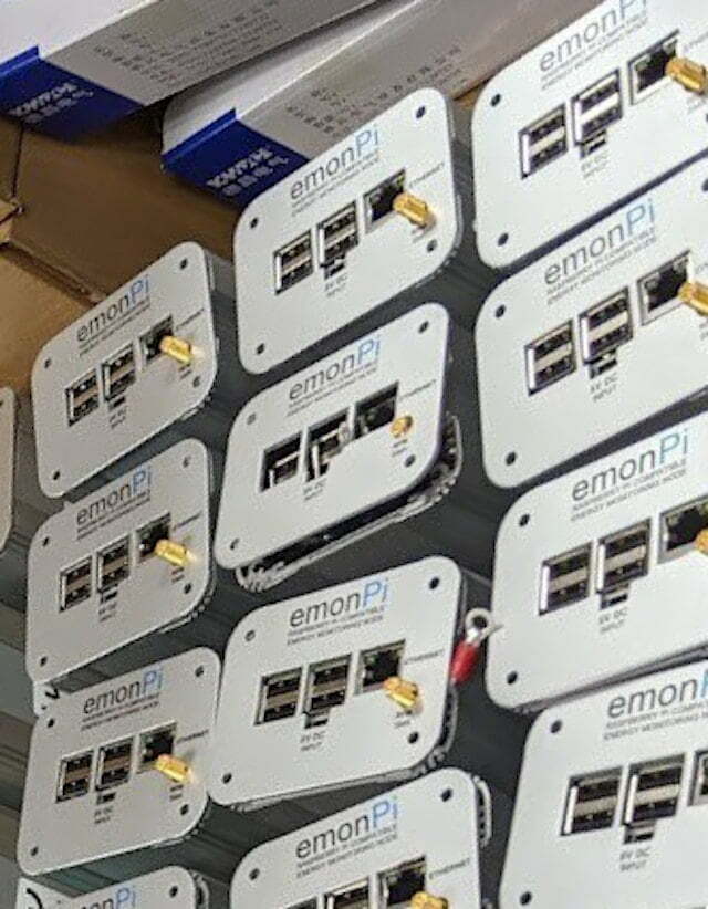 Lots of raspbery pi computers in boxes with extra hardware dongles.