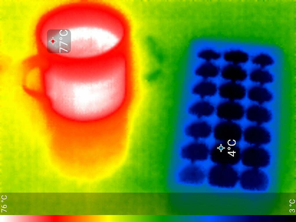 The mug glows red, an indicator shows the contents are 77 degrees. The ice cube tray is black at 4 degrees.