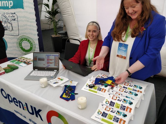 Two white women demonstrating some circuit boards.