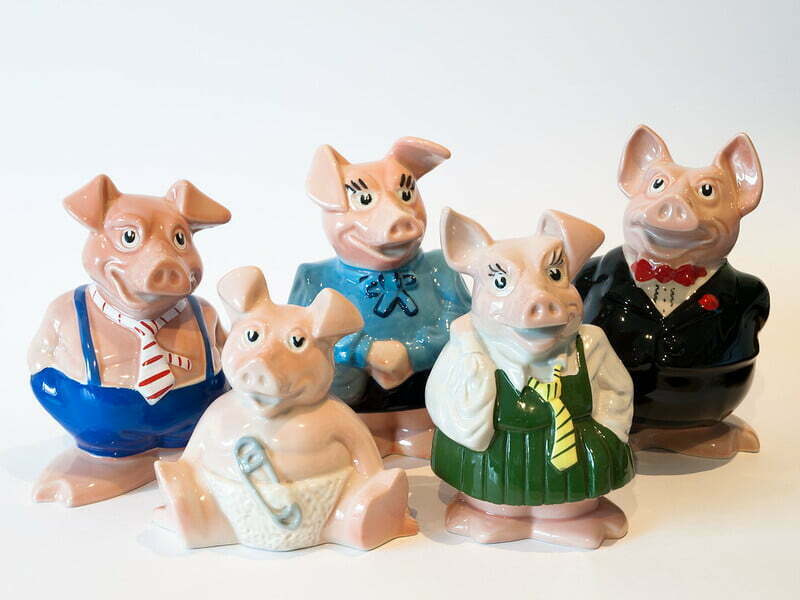 Photos of some porcelain piggy banks in the shape of pigs in clothes. Photo taken by William Warby.