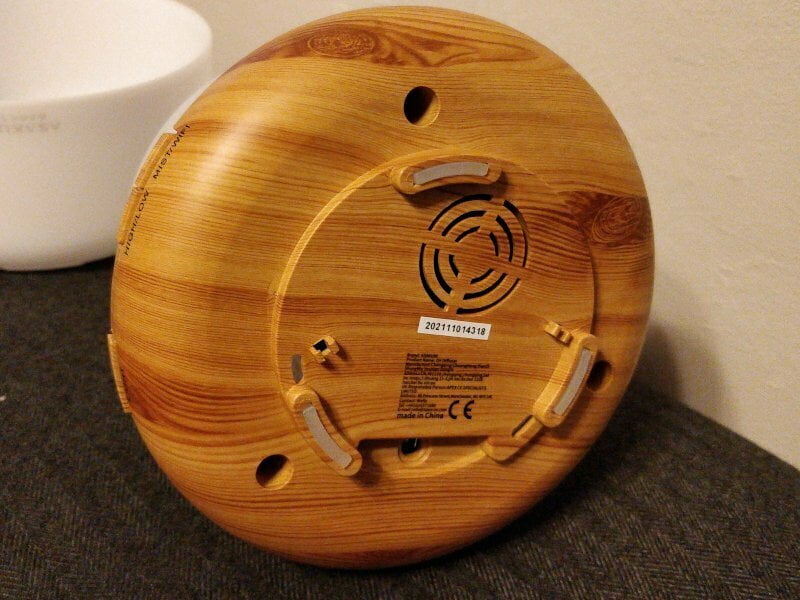 A wooden circle with a power socket on the bottom.