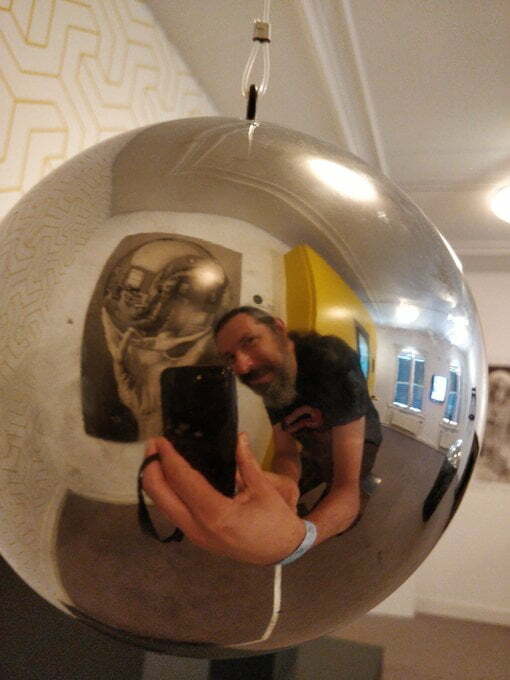 A selfie of Terence reflected in a spherical mirror.