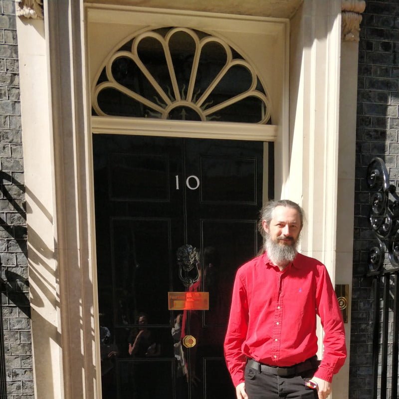 Me wearing a red shirt while outside Number 10.