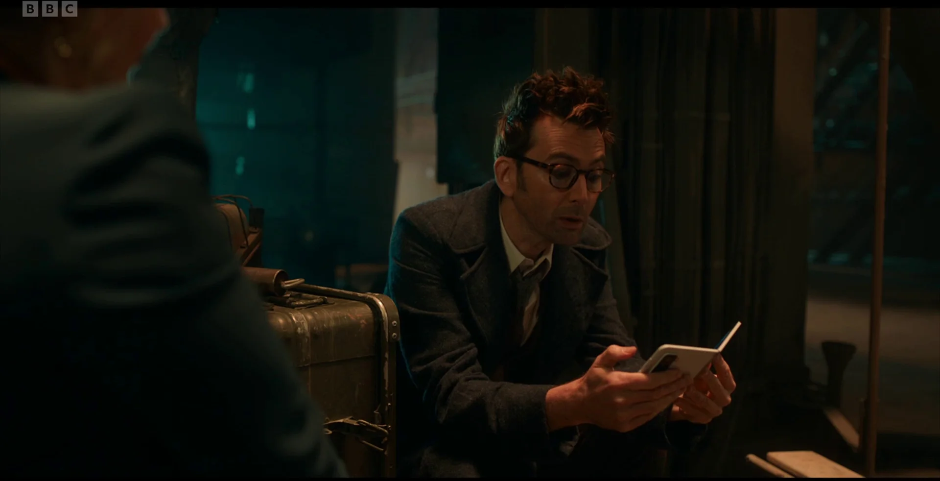 David Tennant's Doctor staring at a phone.