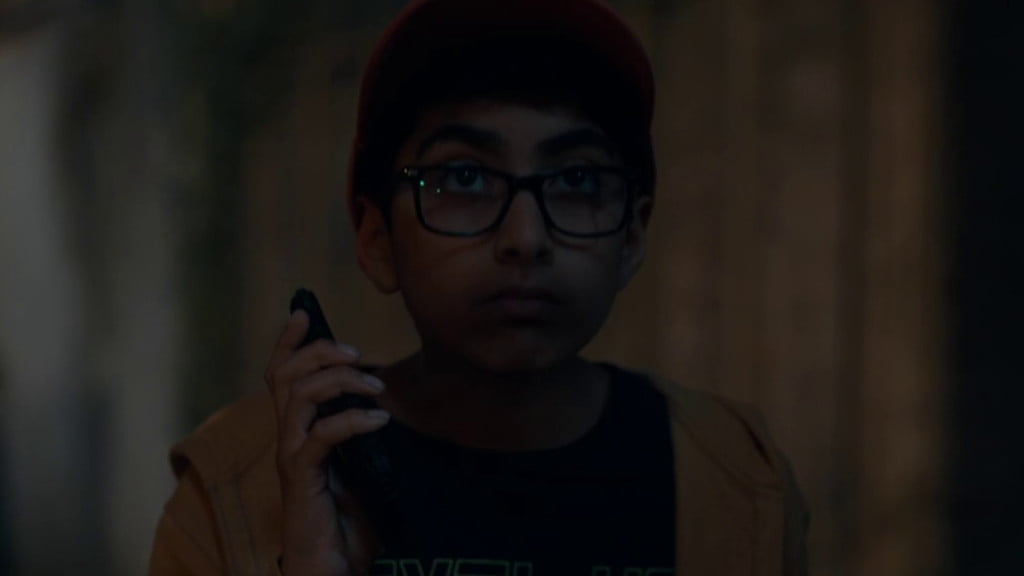 The character of Fudge, a young boy, holding a phone.