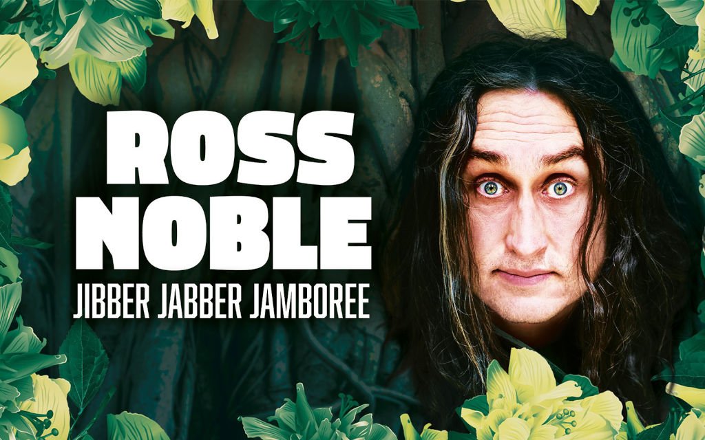 The bewildered face of Ross Noble staring out of a jungle.