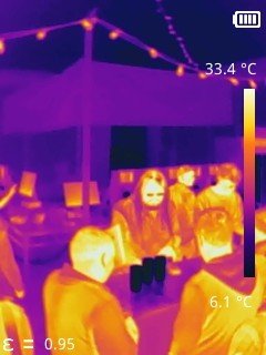 Thermal image showing warm humans next to cold beer.