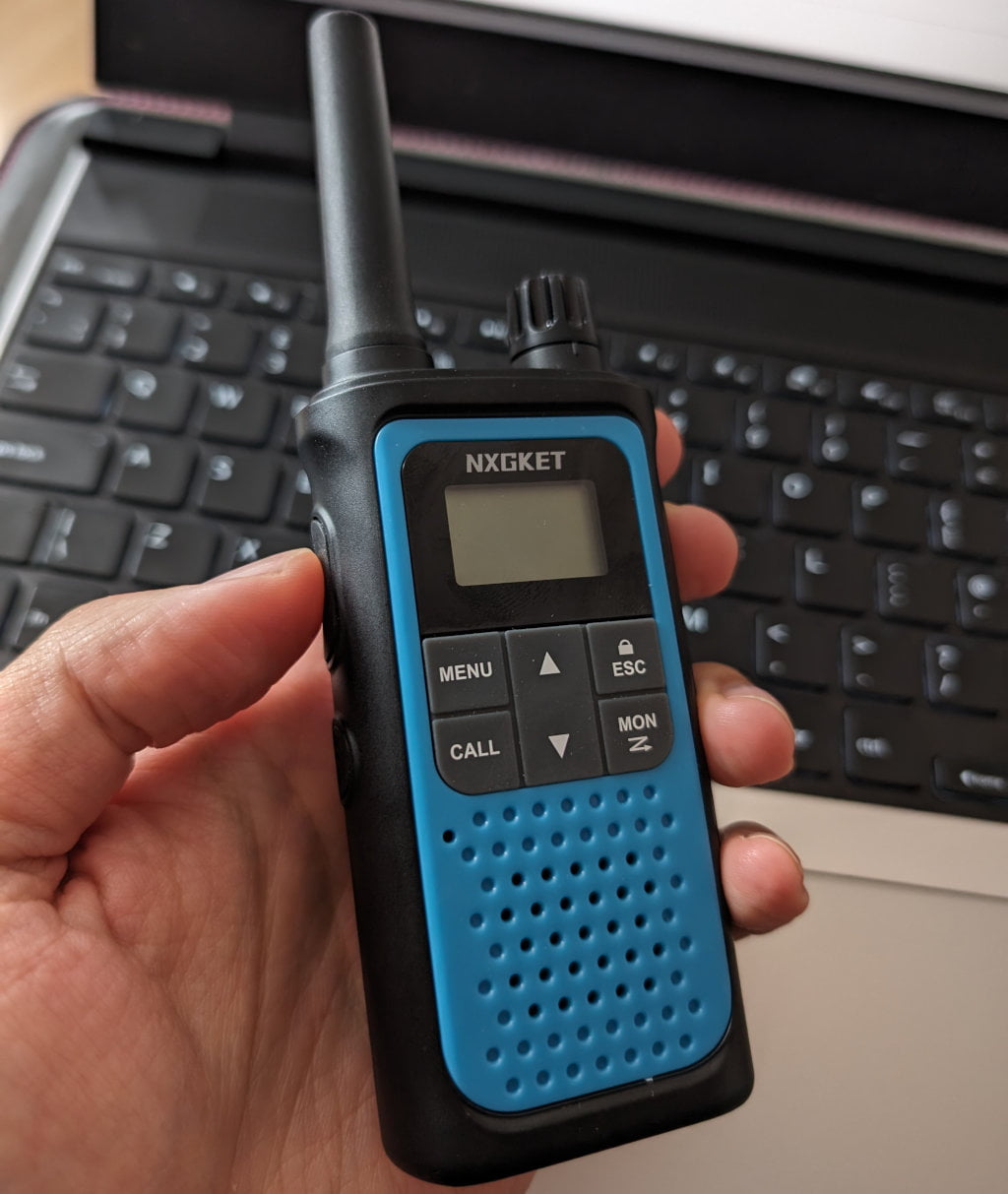 Small blue radio in hand.