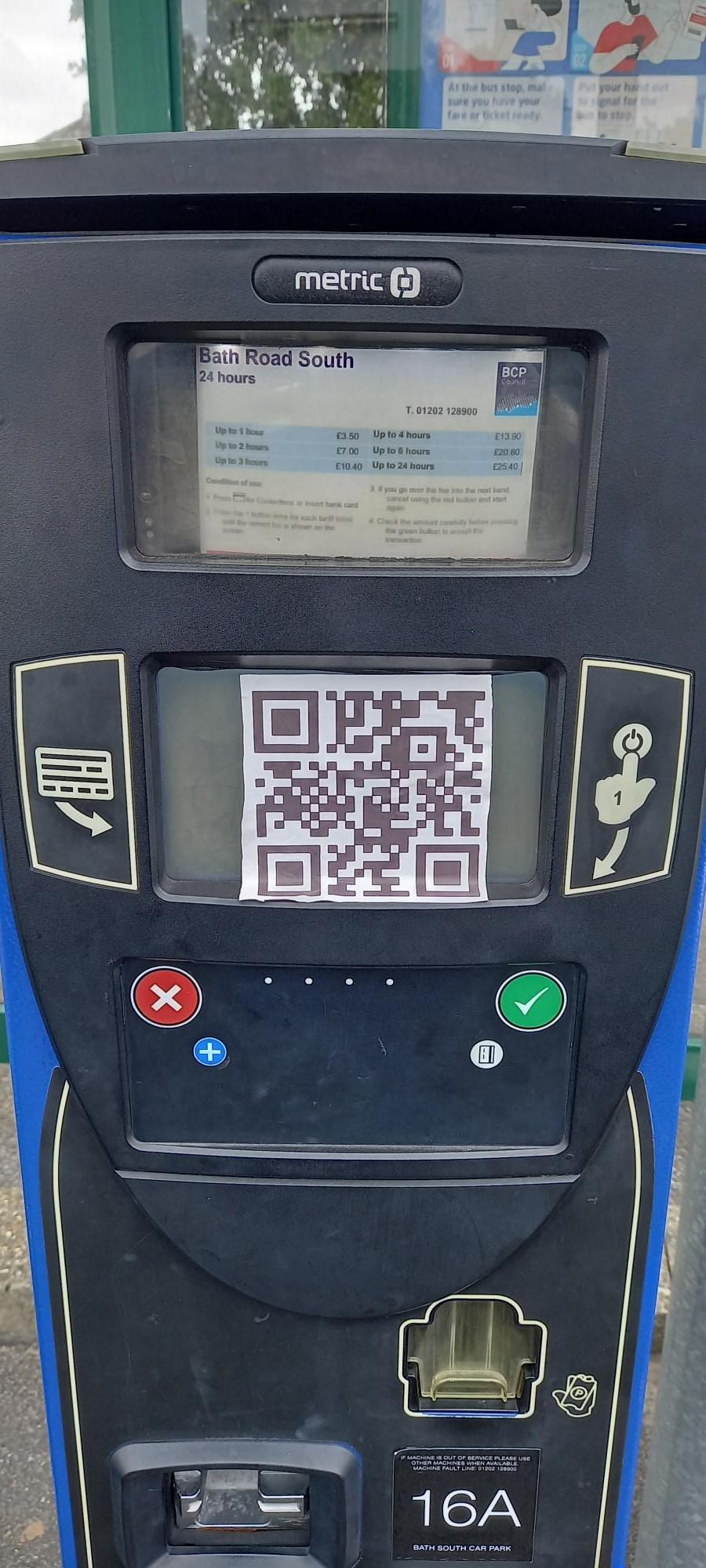 A paper code stuck onto a payment machine.