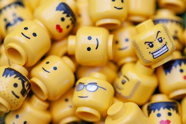 Pile of Lego minifig heads each with a different expression. Image by Andrzej Rembowski from Pixabay.