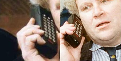 Colin Baker holding a phone with a red logo at the bottom.