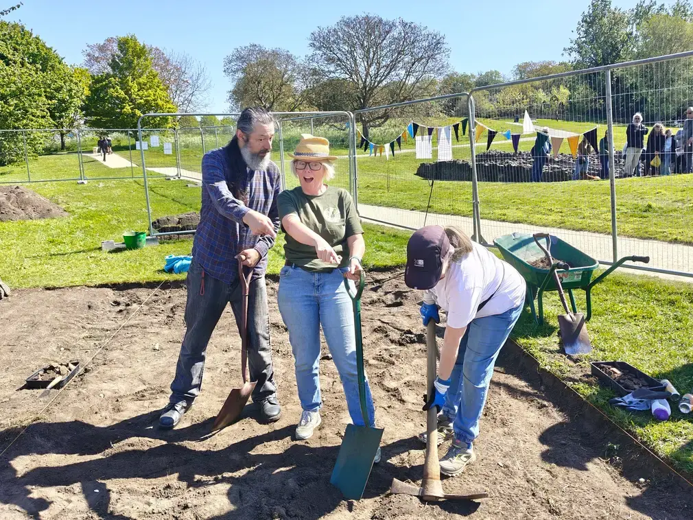 Me and another volunteer pointing excitedly into the dirt.