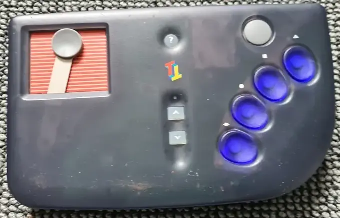 Game controller. Four blue buttons and a primitive touch screen with a red background.