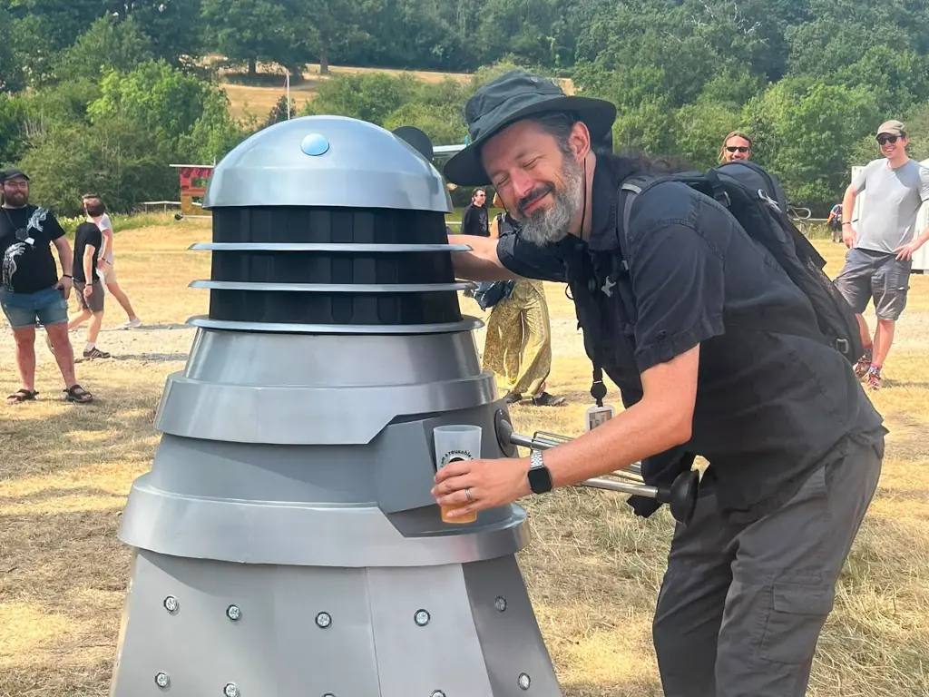 Me hugging a Dalek in a field.