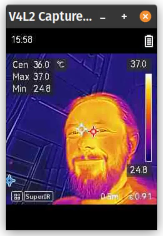 Screenshot of a thermal image of a smiling man.
