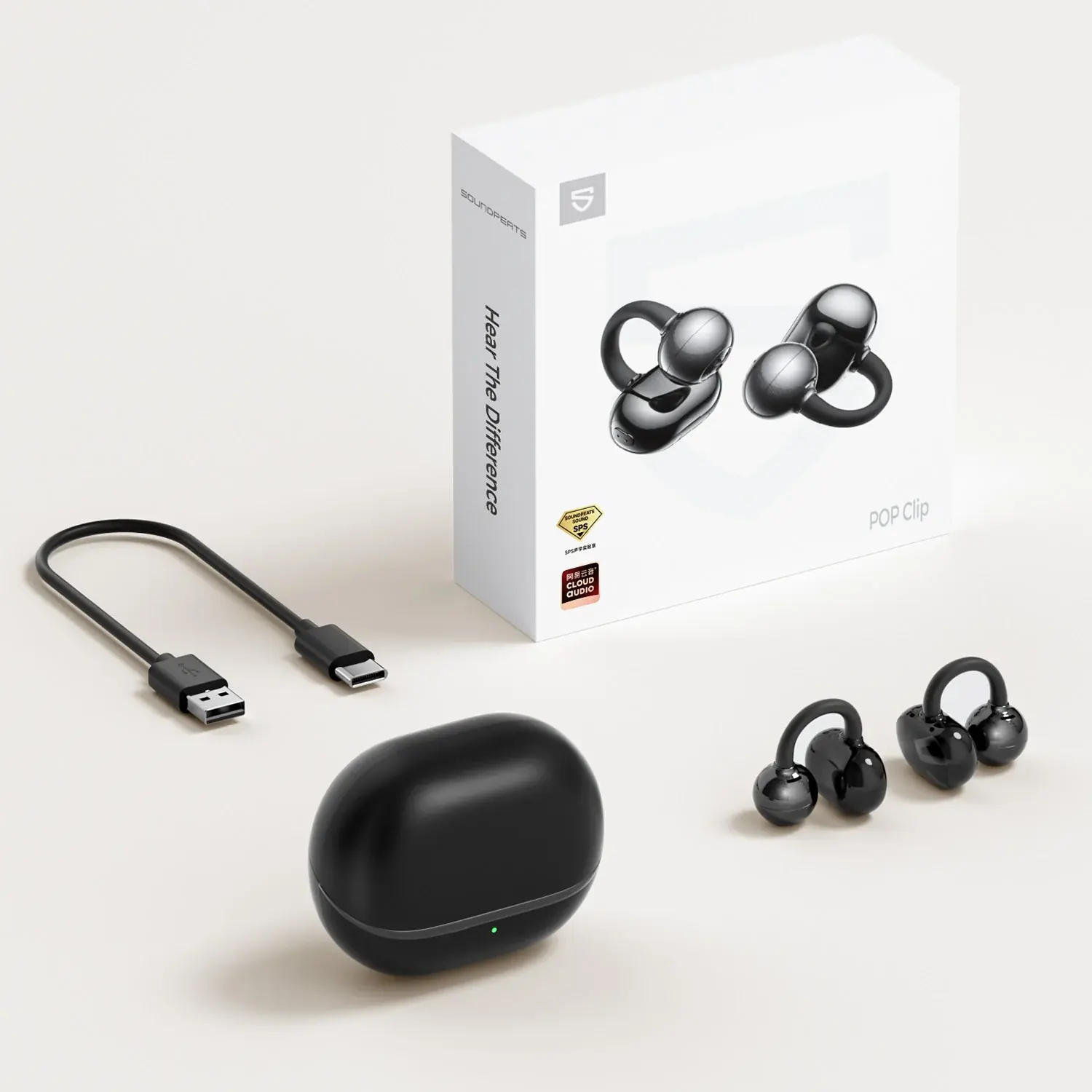 A small cuff style headphone set, charging box, and short cable.