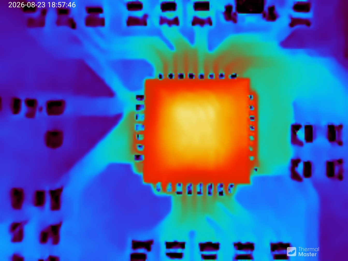 Close up of a small chip. It is hot, the traces are visible in the background.