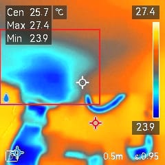 A thermal image with a blue area highlighted with a red outline.