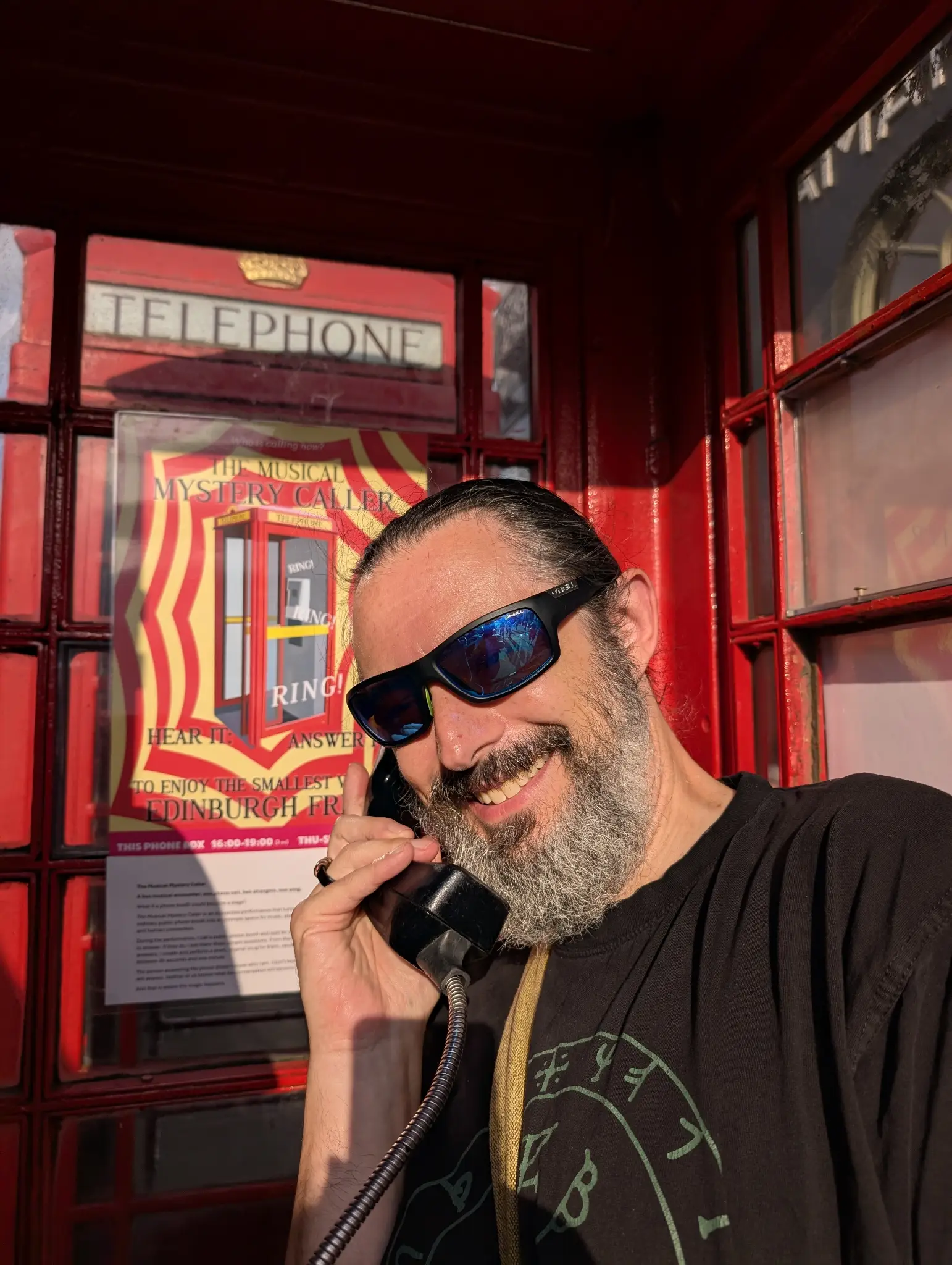 Me in a phone box listening intently.