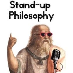 A Greek philosopher wearing sunglasses and speaking into a microphone.