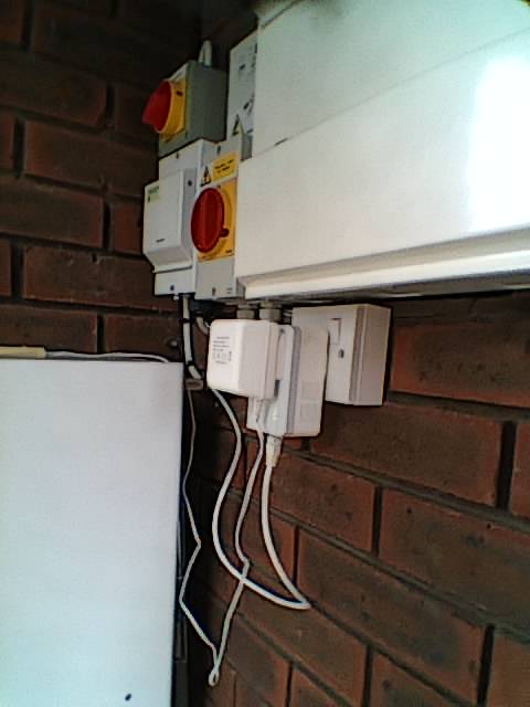 Photo of a plug by a consumer unit.