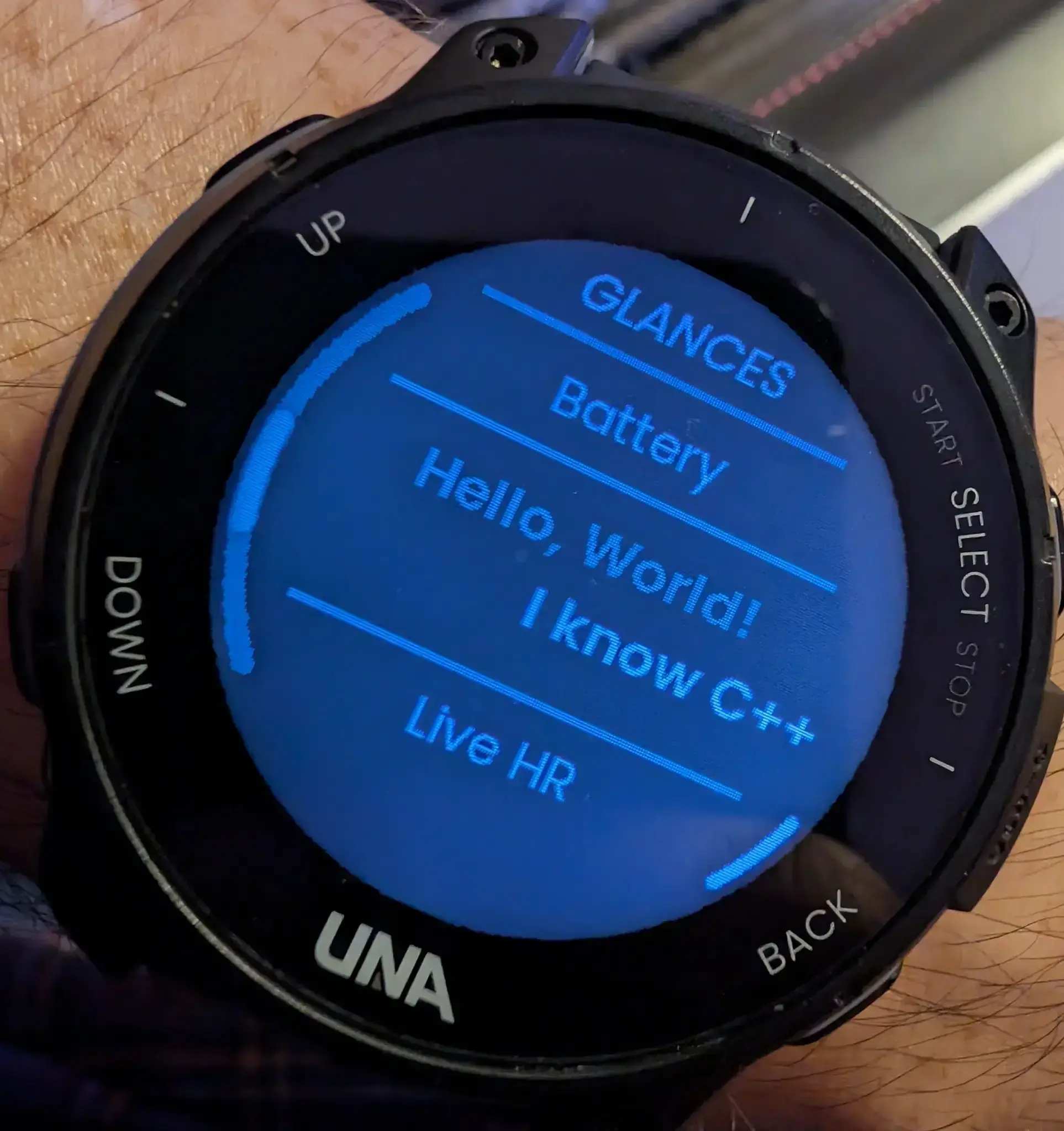 A watch displaying "Hello World" and "I know C++". The latter if off centre because I don't know C++.