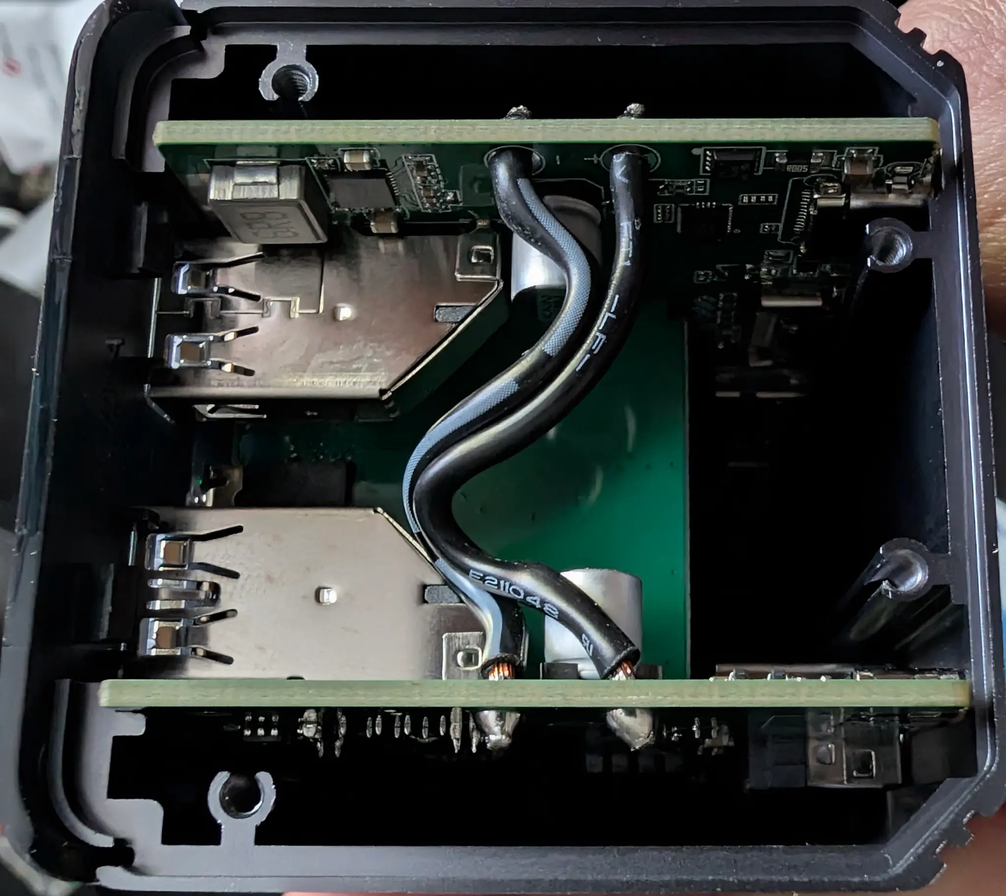 Two circuit boards with a middle board and some wires.